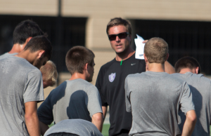 Coach Jon Lowery instructs the St. Thomas men's soccer team on a drill. The Tommies won 3-2 against the Milwaukee School of Engineering in its first week of the season. (Sean Crotty/TommieMedia)