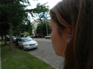 A student listens to music on her way to campus. On Aug. 31, a Minneapolis woman was hit and killed by a Green Line and is thought to have been wearing headphones at the time. (Lauren Schaffran/TommieMedia)