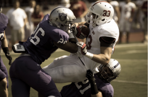 Defensive backs Bennet Celichowski and A.J. Stetson bring down a Johnnie ballcarrier. St. Thomas trailed St. John's 14-7 at halftime. (Jake  