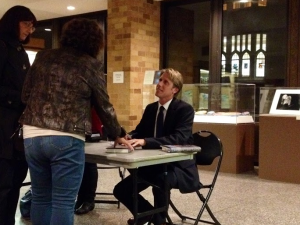 New York Times reporter John Branch signs copies of his book, "Boy On Ice: The Life and Death of Derek Boogaard," after speaking at St. Thomas Thursday. Boogaard, a former Minnesota Wild player, died from a painkilling drug overdose in 2011 after sustaining many concussions. (Kathleen Murphy/TommieMedia)