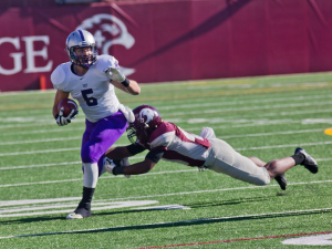 Running back Jack Kaiser evades an Auggie defender on a run during the first half last season. St. Thomas will take on Augsburg, which has scored more than 130 points this season, on Saturday. (Andrew Stafford/TommieMedia)