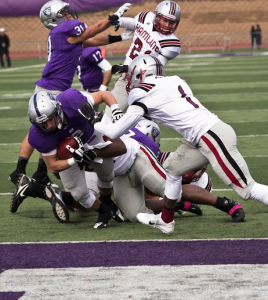 Running back Nick Waldvogel rushes four yards for a St. Thomas touchdown. The Tommies rushed for a total of 232 yards against Hamline last year, while the Pipers tallied 184. (Eric Wuebben/TommieMedia)
