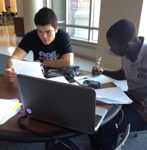 St. Thomas students Dacotah Anderson and Nasser Lubega work on homework in the Anderson Student Center. Christopher Gregg, interim vice president of IRT, said increased Wi-Fi use caused St. Thomas’ wireless network to reach its capacity campus. (Margaret Murphy/TommieMedia)