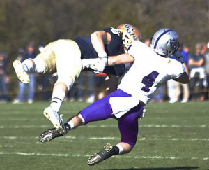 Wide receiver Jack Gilliland and a Bethel defender dive for an overthrown ball. Gilliland caught eight balls for 102 yards Saturday. (Madeleine Davidson/TommieMedia)