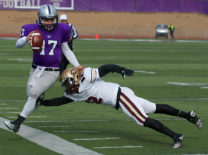 Quarterback John Gould gets pushed out of bounds on a keeper. St. Thomas leads Concordia-Moorhead 14-7 at halftime. (Elena Neuzil/TommieMedia)
