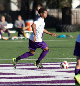 Forward Miles Stockman-Willis possesses the ball at midfield in a game against St. Ben's this season. The men's soccer team's season ended with a 2-0 loss to Carleton in the MIAC quarterfinals Tuesday. (Madeleine Davidson/TommieMedia)