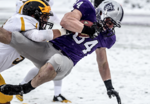 Tight end Cole Kelly is thrown to the ground after a 27-yard reception near the end of the half. The senior’s catch led to a seized red zone scoring opportunity for the Tommies with three seconds remaining. (Jake Remes/TommieMedia)