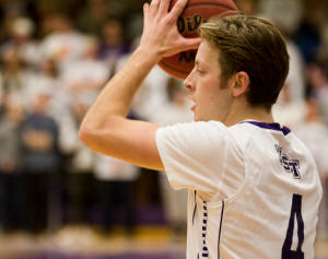 Guard Grant Shaeffer grips the ball on the wing in a playoff game against Bethel last season. St. Thomas starts the season with a host of veterans on the roster, including six players who have starting experience and 13 total letter winners. (Andrew Stafford/TommieMedia) 