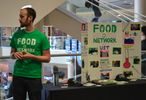 Co-President of the Food Recovery Network at St. Thomas, Adam Gilliam, hands out stickers and flyers to students passing outside of The View to showcase the organization. The network began at St. Thomas last semester. (Whitney Oachs/TommieMedia)