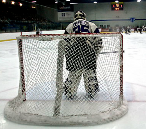 Goaltender Drew Fielding watches the play at the opposite end of the ice in St. Thomas' game against Hamline. Fielding led the Tommies to four-straight conference titles and career with his third consecutive All-Conference honor. (Carlee Hackl/TommieMedia)