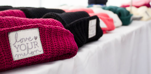 Felt-stitched Love Your Melon were on display available for purchase at a homecoming event at St. Thomas last year. The non-profit organization has sold enough hats to donate one to every child with cancer in America.  (Andrew Stafford/TommieMedia) 
