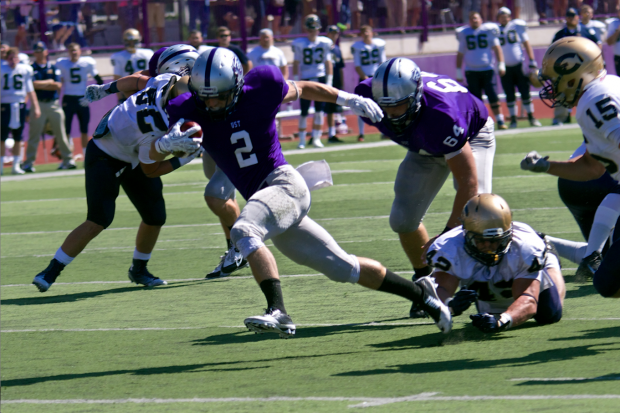 Running back Nick Waldvogel breaks away from a defender during St. Thomas’ 22-17 victory over Wisconsin-Eau claire last season. The Tommies open the 2015 season against the Blugolds Saturday at Carson Park. (Jake Remes/TommieMedia)