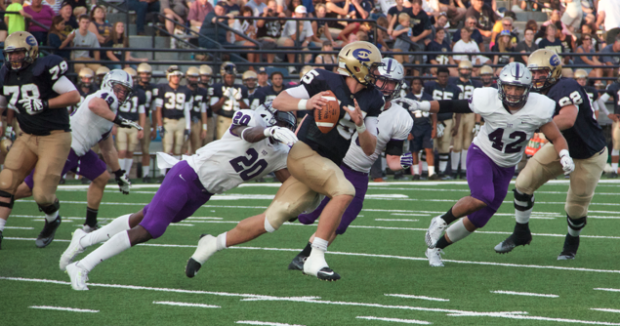Linebacker Jesse Addo lunges to take down Wisconsin-Eau Claire quarterback J.T. DenHartog. The Tommies lead the Blugolds 38-0 at halftime Saturday. 