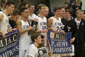 Members of the St. Thomas men's basketball team pose with their hardware after winning the MIAC title last season. The Tommies lost significant players but return some of the best talent in the MIAC this year. (Andrew Brinkmann/TommieMedia)