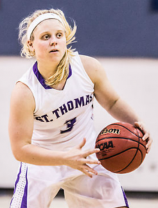 Guard Katie Stone scans the court for an open teammate. Stone is one of two seniors on the St. Thomas women's basketball team this season. (Jake Remes/TommieMedia) 