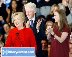 Democratic presidential candidate Hillary Clinton speaks in front of former President Bill Clinton and daughter Chelsea during a caucus night rally at Drake University in Des Moines, Iowa, Monday. (AP Photo/Patrick Semansky)