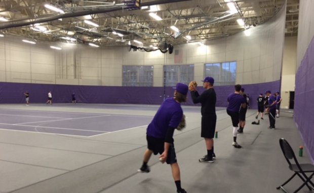 The St. Thomas baseball team gets loose before practice inside the Anderson Athletic and Recreation Complex. The Tommies beat Augsburg 3-2 in the first game of a doubleheader Wednesday afternoon. (Taylor Smith/TommieMedia)