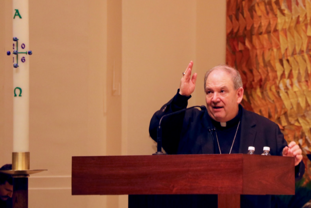 Archbishop Hebda blesses the audience after speaking at Tuesday's TommieCatholic gathering. The Archbishop addressed methods for emulating Pope Francis' leadership skills for students, faculty and community members in the St. Thomas Aquinas Chapel. (Natalie Hall/TommieMedia) 