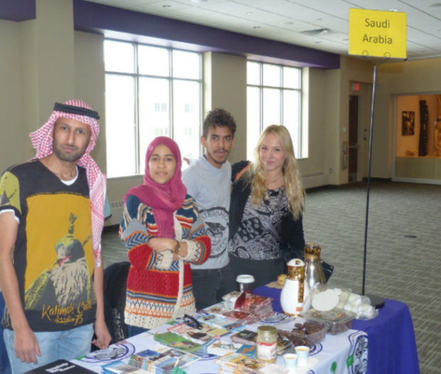 Senior Muhannad Alkathiri and other students present the Saudi Arabian table at the International Fair during International education week. Saudi Arabia is currently the most-represented country in the international student body at St. Thomas, but that may soon change due to potential budget cuts in the country’s government. (Photo credit: Office of International Students and Scholars). 