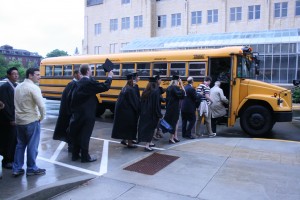 <p>Graduates and their families load onto shuttle buses to get to the Metrodome.</p>