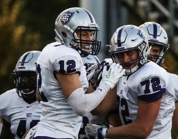 St. Thomas holder Dylan Andrew and offensive lineman Damon Longstreet celebrate after a touchdown. After a slow start, St. Thomas took the lead over UW-Eau Claire with a half-time score of 21-6 (Carlee Hackl/TommieMedia). 