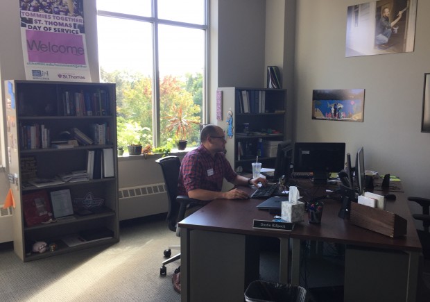 Tommies Together Volunteer Center coordinator Dustin Killpack works in the center's office. The center aims to help Tommies get involved in the community. (Spencer Flaten/TommieMedia) 