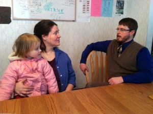 Catherine and David Deavel sit with their daughter Marie at their home in St. Paul. Catherine works in the philosophy department, while David works in the Catholic studies department. (Margaret Galush/TommieMedia)