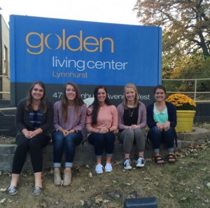 Adopt-A-Grandparent volunteers pose for a photo outside Golden LivingCenter. The volunteer program has grown during the past few years. (Photo courtesy of Adopt-A-Grandparent program.)