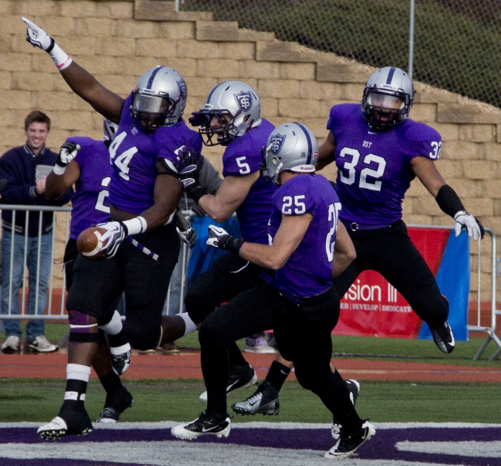 Defensive end Ayo Idowu runs a 25-yard fumble recovery for a touchdown. The touchdown put the Tommies on the board 7-0 within 14 seconds of the first quarter. (Rosie Murphy/TommieMedia)