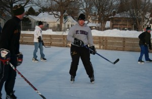 Eric Weslund shoots some puck with friends at Groveland's outdoor ice rink. (Ellie Galgano/TommieMedia)