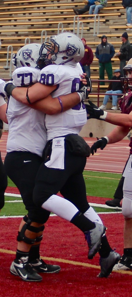 <p>Senior tight end Logan Marks and senior offensive lineman Curtis James embrace after a Tommie touchdown. St. Thomas clinched the MIAC Championship with a 21-7 victory over the Cobbers Saturday. (Rosie Murphy/TommieMedia) </p>