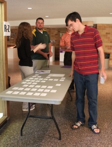 johnmores Freshman John Mores grabs his name tag before entering the first Connect meeting. (Ariel Kendall/TommieMedia)