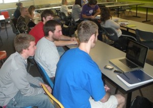  A group of students in Summit Classroom Building watc a game before class starts. (Brian Matthews/TommieMedia)