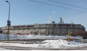 The Minneapolis skyline peers over the roof-less Metrodome. The Dec. 12 roof-collapse caused the St. Thomas baseball team to cancel four games that it was supposed to play there.