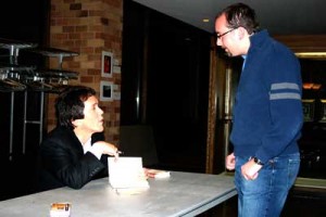 Author Mitch Albom signs a fan's book after his speech Sunday night in the OEC auditorium. (Shane Kitzman/TommieMedia)