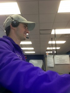 A phone center talks with a potential donor on his headset. The center is using a new game to motivate student employees and boost donation amounts. (Luke Moe/TommieMedia)