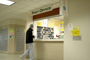 postoffice <p>Sophomore Charles Bruchu sends a letter Wednesday afternoon at the post office. (Shane Kitzman/TommieMedia)</p>