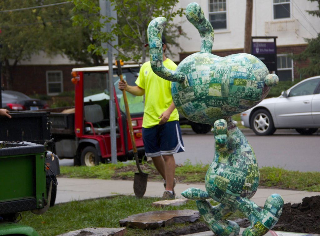 <p>St. Thomas grounds workers landscape around the donated Snoopy statue on July 24, 2012. The St. Thomas alumnus, who wants to remain anonymous, worked with the university when he chose from the archives to decorate Snoopy's surface. (Hannah Anderson/TommieMedia)</p> 