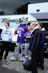 Tommie cheers the softball players on as they pack the bus to leave for their tournament. (Gina Dolski/TommieMedia)