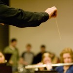 <p>Matthew George directs the Symphonic Wind Ensemble during reherseal this week. The ensemble travels to Italy Jan. 16 - 26 and will play five concerts. (Aaron Hays/TommieMedia)</p>