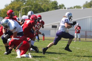 <p>Senior running back Colin Tobin breaks free for a huge gain last week against UWRF. He rushed for 121 yards and four touchdowns. (Ryan Shaver/TommieMedia)</p>