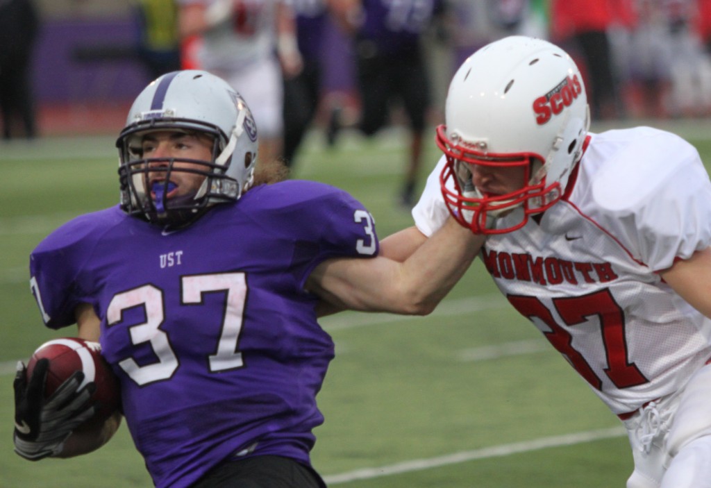 Senior running back Colin Tobin stiff arms a Monmouth defender. (Alex Keil/TommieMedia)