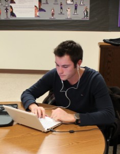 <p>Junior Corentin Auguin uses his laptop in the Blue Lagoon. IRT hopes an increase in bandwidth capacity will help students avoid slow connections.</p>