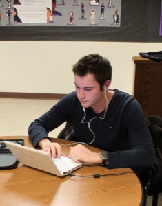 usingcomputerHD <p>Junior Corentin Auguin uses his laptop in the Blue Lagoon. IRT hopes an increase in bandwidth capacity will help students avoid slow connections.</p>